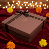 Gift box with a bow on a red fabric background with flowers