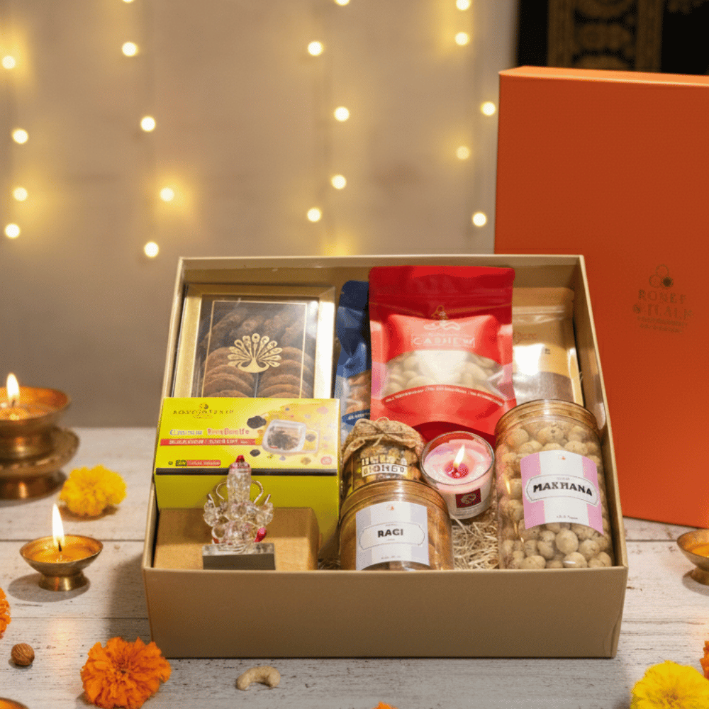 Diwali Gift Hamper that includes Nuts & Honey, Cashew, Almonds, Makhana, Ragi Chips, Multigrain Cookies, Filter Coffee, Green Tea, Ganesha Figurine & Candle