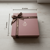 Brown gift box with a brown ribbon and 'Roses & Tulip' branding, measured at 10x10 inches on a light wooden surface.