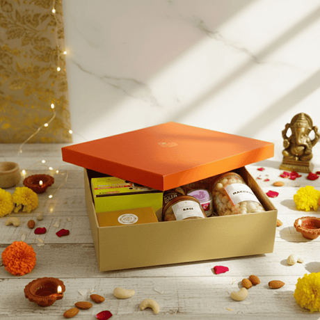 Diwali Gift Hamper that includes Nuts & Honey, Cashew, Almonds, Makhana, Ragi Chips, Multigrain Cookies, Filter Coffee, Green Tea, Ganesha Figurine & Candle